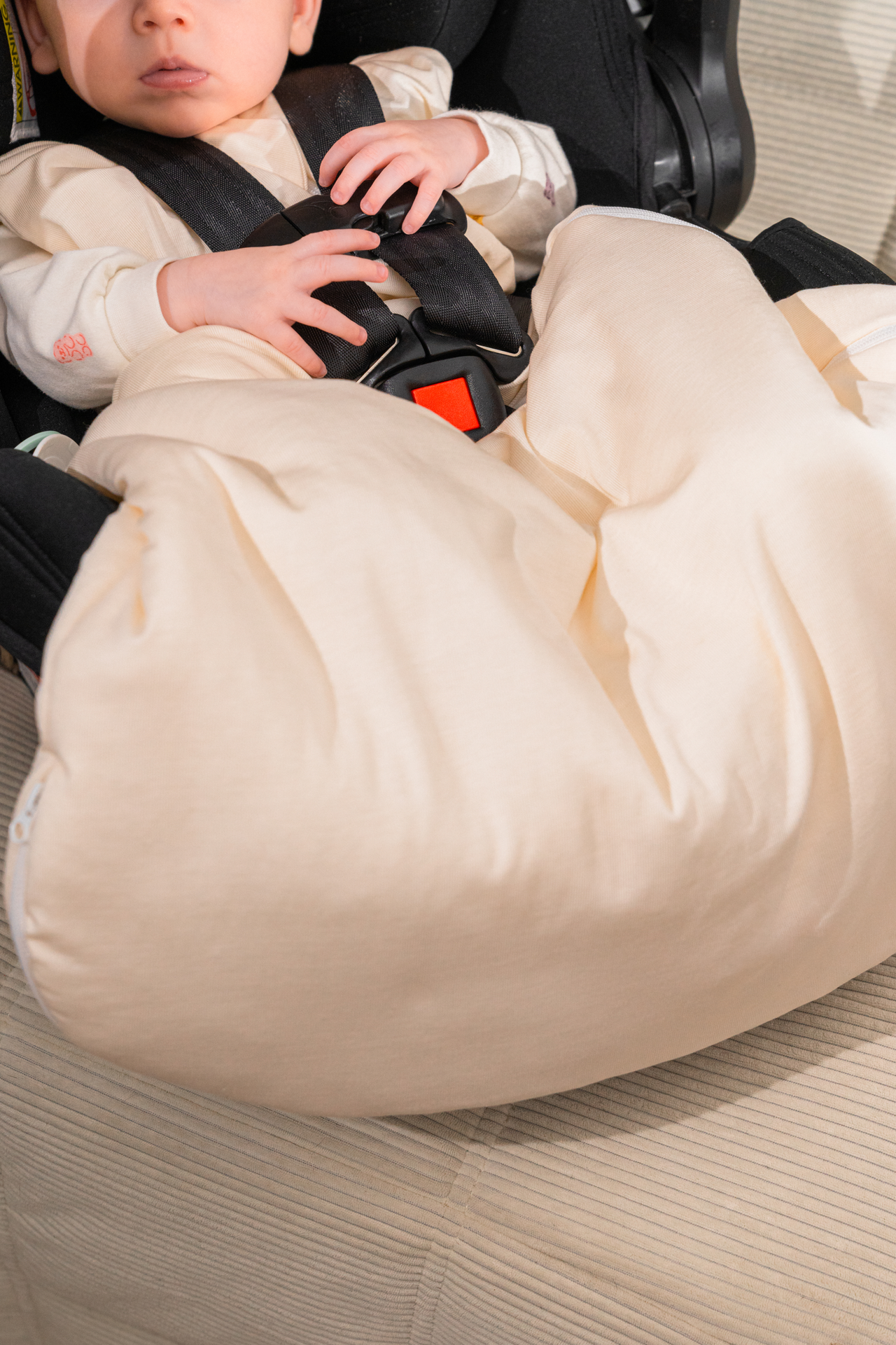 Sleeping baby transferred from car seat to crib in the Morpheia sleep sack